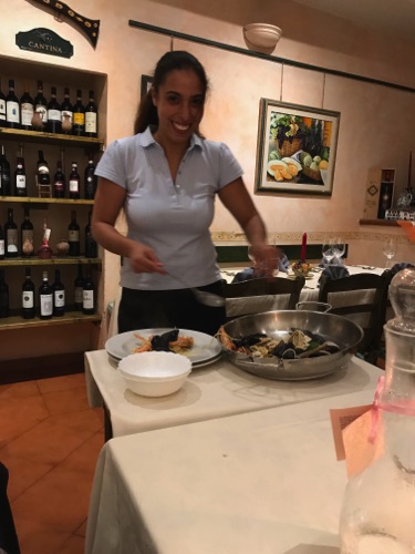 waitress serving our fish pasta