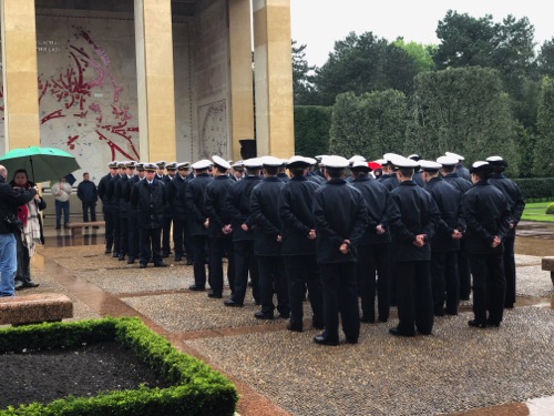 French air force cadets saluting toward  the cemetery